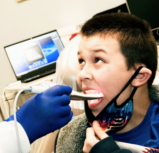 A boy receiving dental work done.