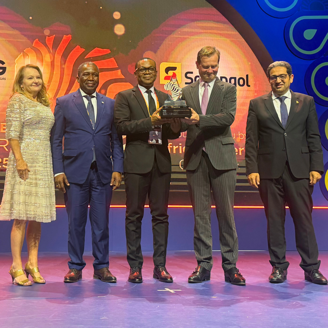 Photo shows group of people holding award on stage