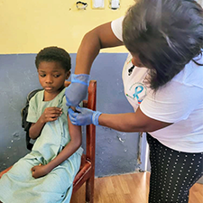 Girl receiving HPV vaccine in classroom