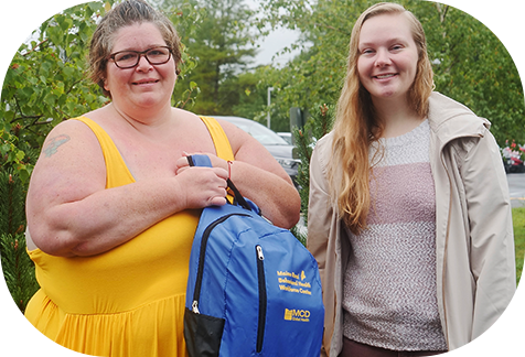 Training participate receives a backpack filled with helpful supplies for a recovery career