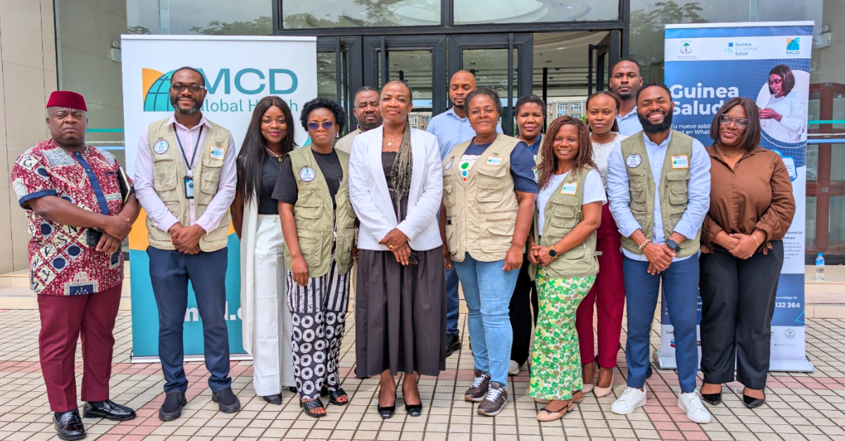 Group of people with some wearing BIMEP vests posing for the camera outside
