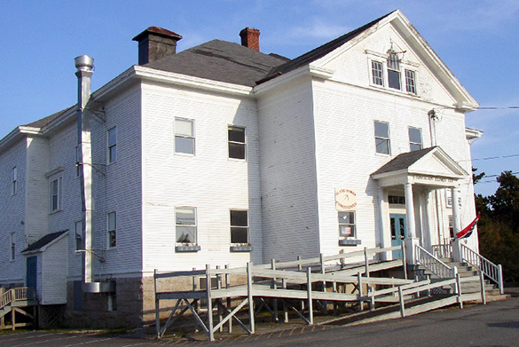 Photo of the old Stonington Schoolhouse, large white building.