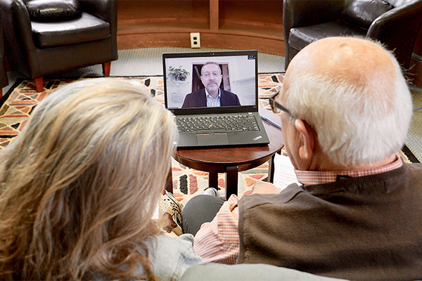 Couple using telehealth technology with doctor.