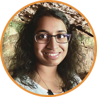 Woman wearing glasses smiling at camera.