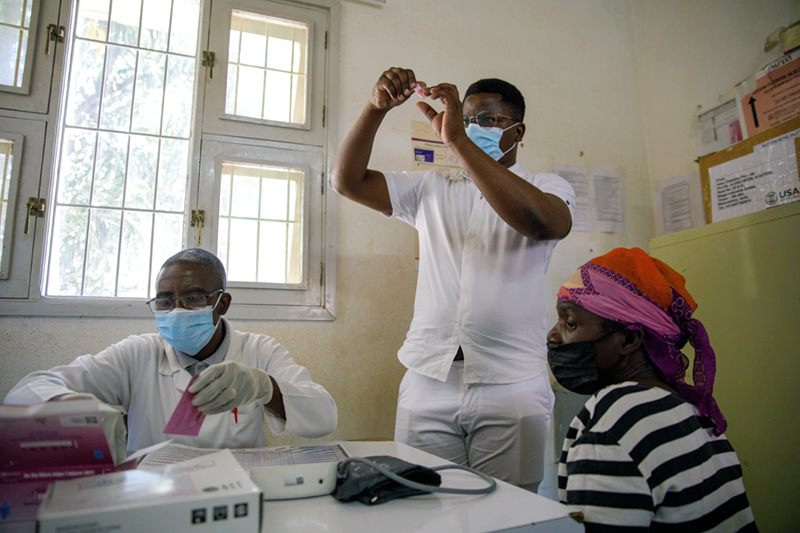 Rafael Roque conducting a malaria test at a health facility in Mozambique